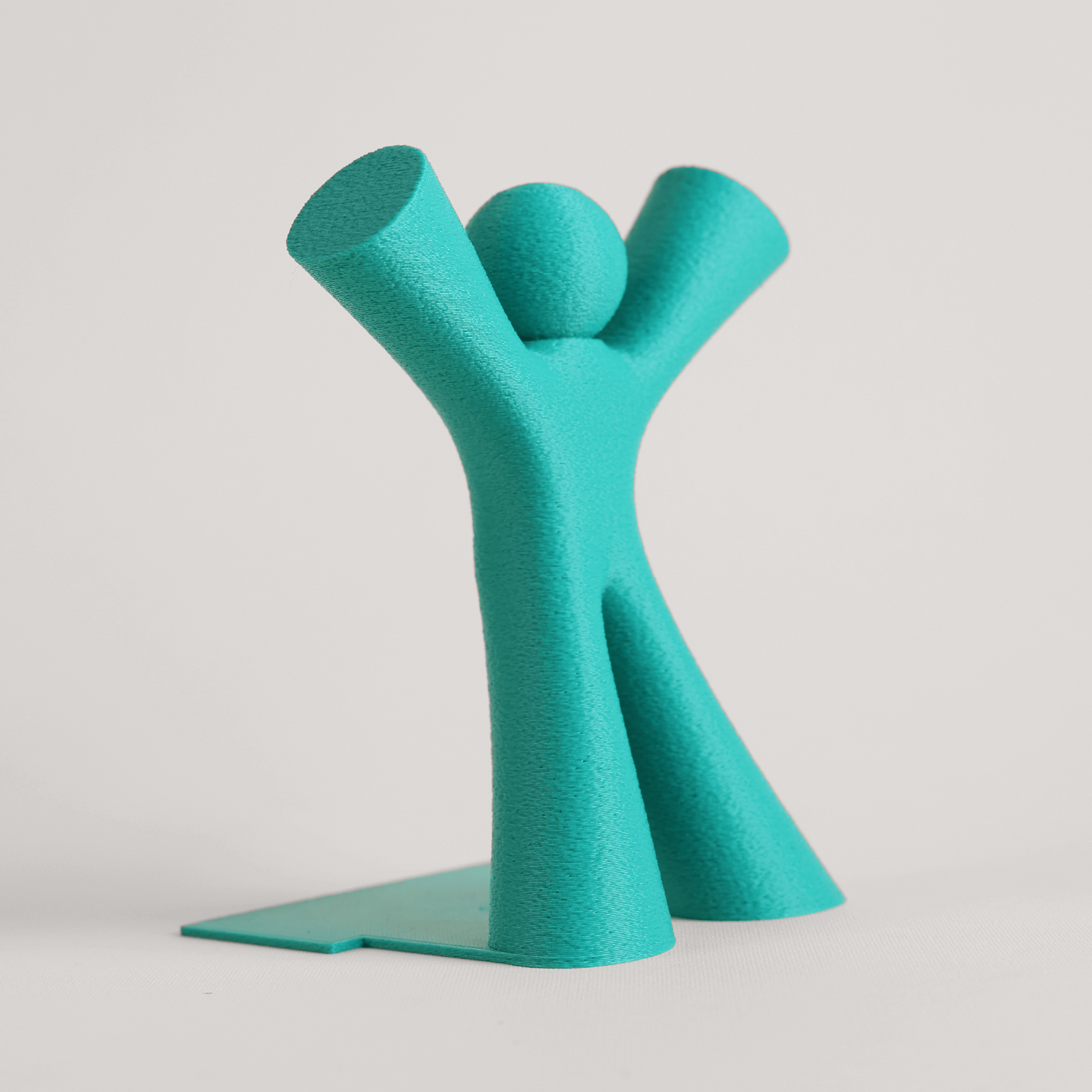 Teal abstract character bookend on a light gray background