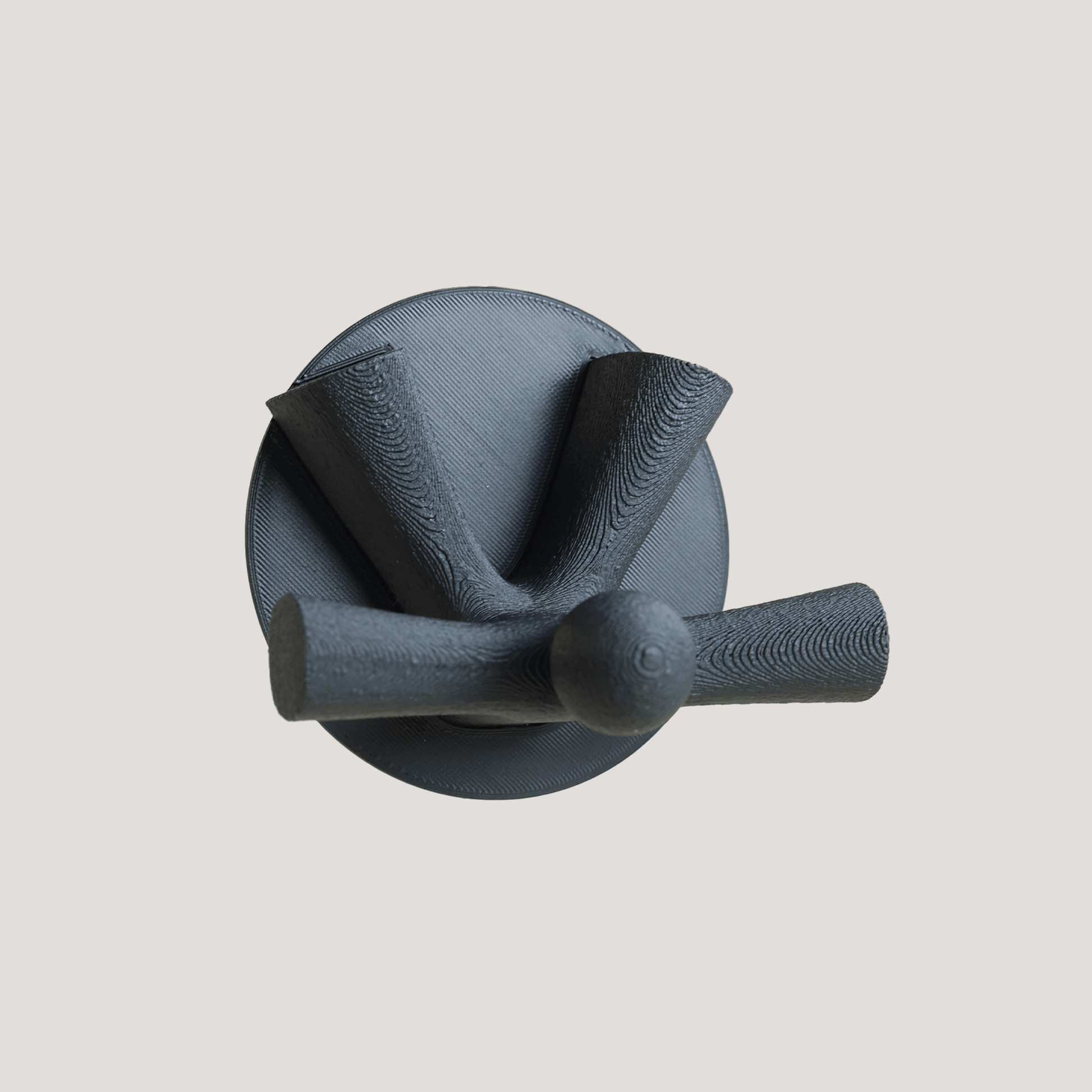 black character shaped wall hook on a light gray background